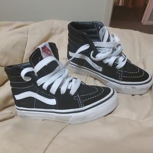 Black and white high top vans